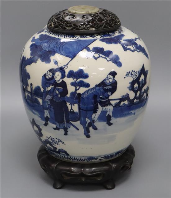 A large Chinese blue and white jar, Kangxi mark, 19th century, the wood cover inset with a jade plaque height 34cm